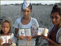 Children showing pictures of their missing fathers